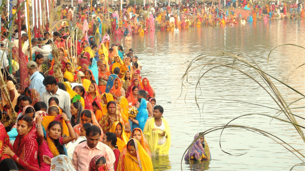 Devotees celebrating Chhath Puja in city ghats with traditional rituals